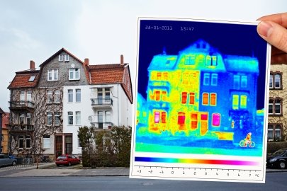 Exterior of a large house on a street, with a hand holding a thermal image of the house in the foreground.